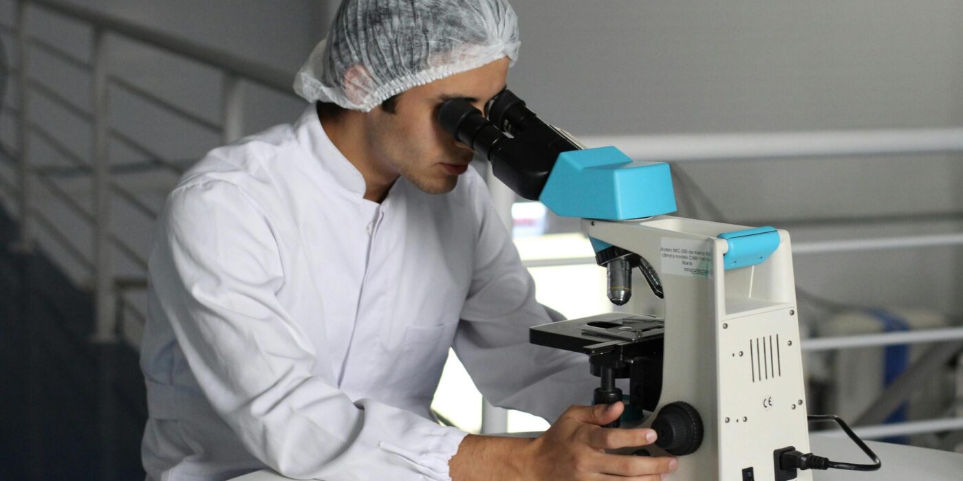 Research team analyzing biological samples under a microscope.